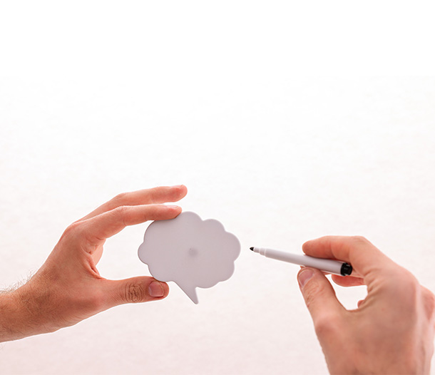 Two hands holding marker drawing smart quotes