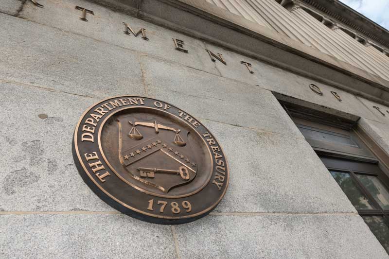 US Treasury Department building, with seal near one entrance.