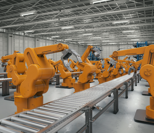 BCP_Manufacturing | LG Networks, Inc. Row of yellow robotic arms working along a roller conveyor in a spacious factory.